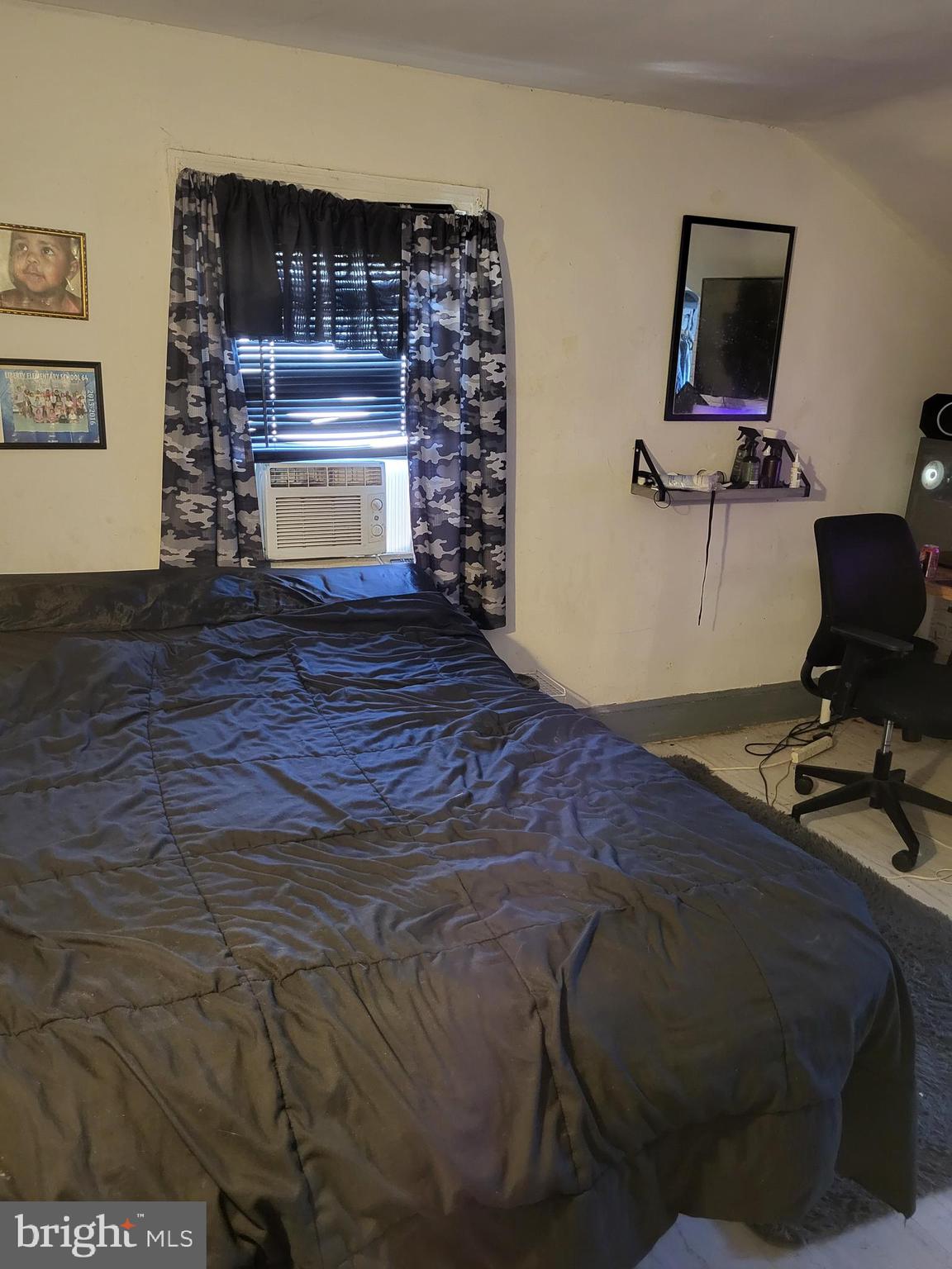 2806 Chelsea Terrace Baltimore, MD 21216 - Photo 25 of 36 a bed sitting in a room next to a window