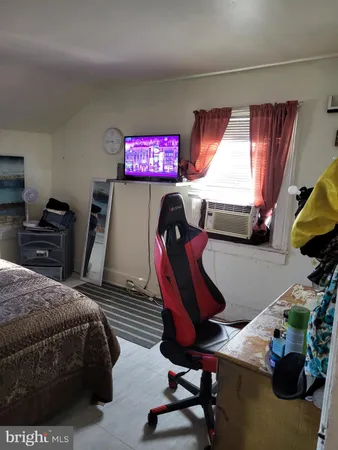 a bedroom with furniture and a window