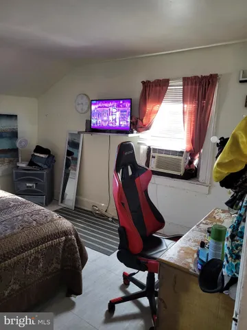 a bedroom with furniture and a window