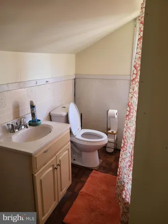 a bathroom with a sink a toilet and mirror