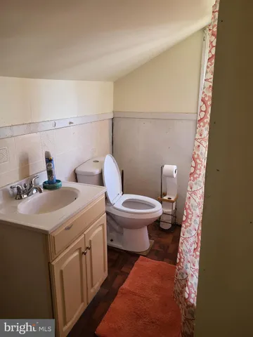 a bathroom with a sink a toilet and mirror