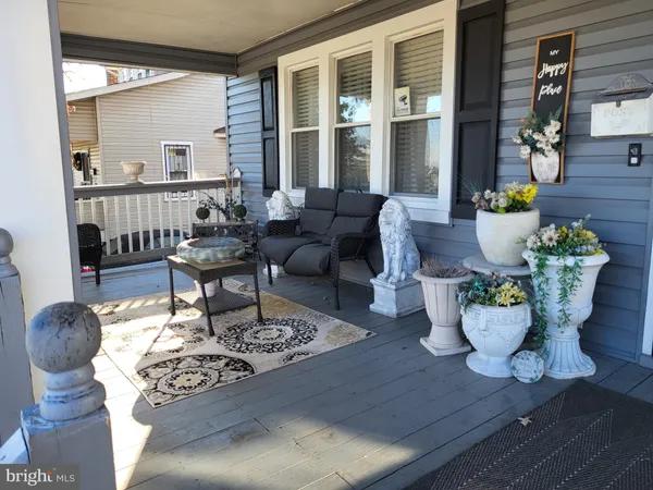 a living room with furniture a table and a potted plant