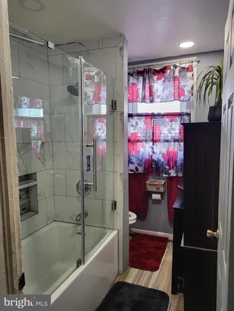 a bathroom with a bathtub and a shower