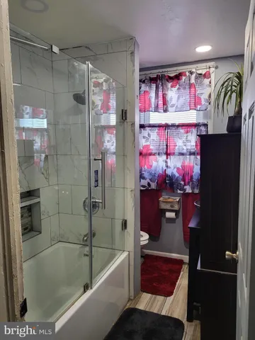 a bathroom with a bathtub and a shower