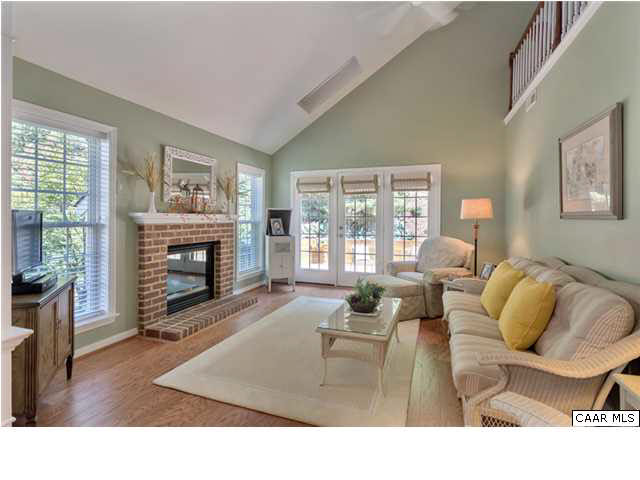 976 Devon Spring Court Charlottesville, VA 22903 - Photo 8 of 33 The family room features a vaulted ceiling exposing the loft upstairs and so much natural light. Heading out to the patio, the current owner had a frame built and added a storm door. Custom roman shades were installed on the french doors.