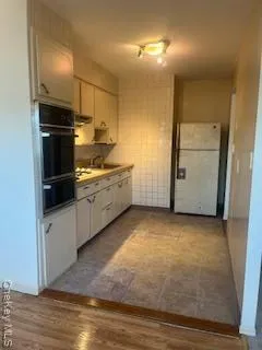 a kitchen with cabinets and stainless steel appliances