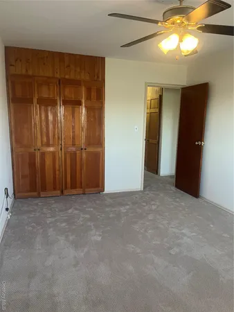 an empty room with windows and closet