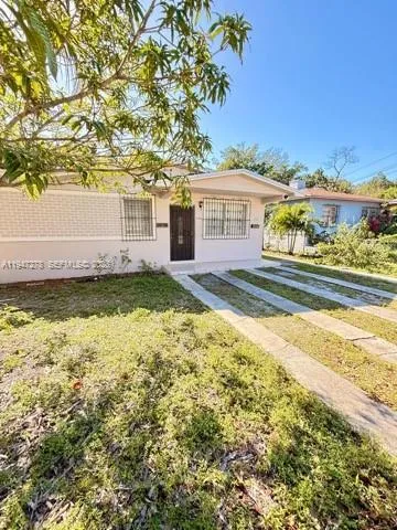 a view of a house with a swimming pool and a yard