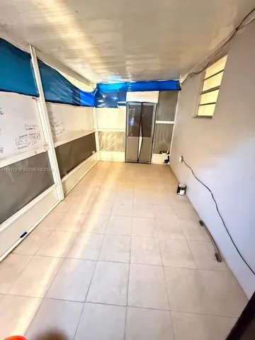 a view of a patio with table and chairs