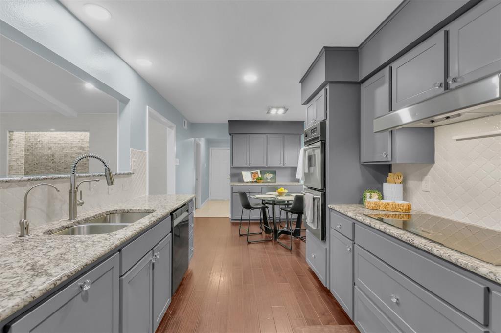 4808 Thunder Road Dallas, TX 75244 - Photo 19 of 36 a kitchen with granite countertop a sink stove and cabinets