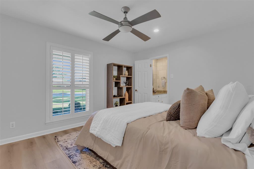 4808 Thunder Road Dallas, TX 75244 - Photo 27 of 36 a bedroom with a large bed and a chandelier