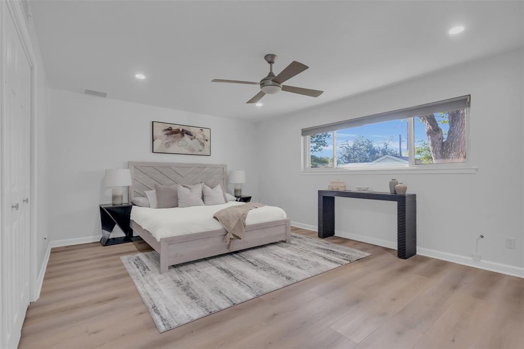 4808 Thunder Road Dallas, TX 75244 - Photo 35 of 36 a bedroom with a large bed and a chandelier