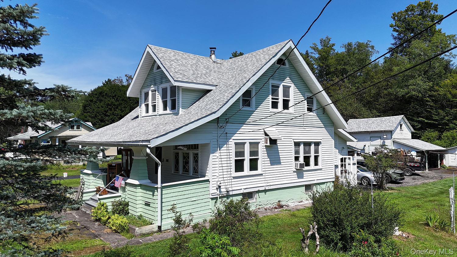 1779 Shandelee Road Livingston Manor, NY 12758 - Photo 28 of 31 View of side of home with covered porch and roof with shingles