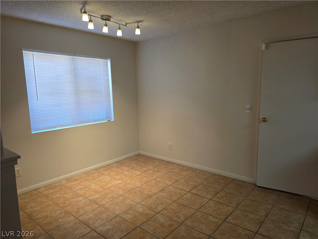 5289 Reeder Circle Las Vegas, NV 89119 - Photo 9 of 40 Tiled flooring and track lighting define this versatile room with a large window.