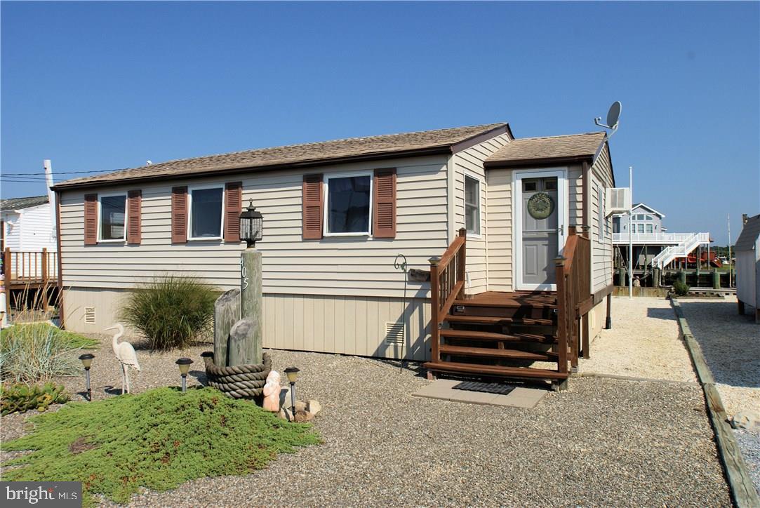 405 Kingfisher Road Tuckerton, NJ 08087 - Photo 1 of 16 a front view of a house with a yard