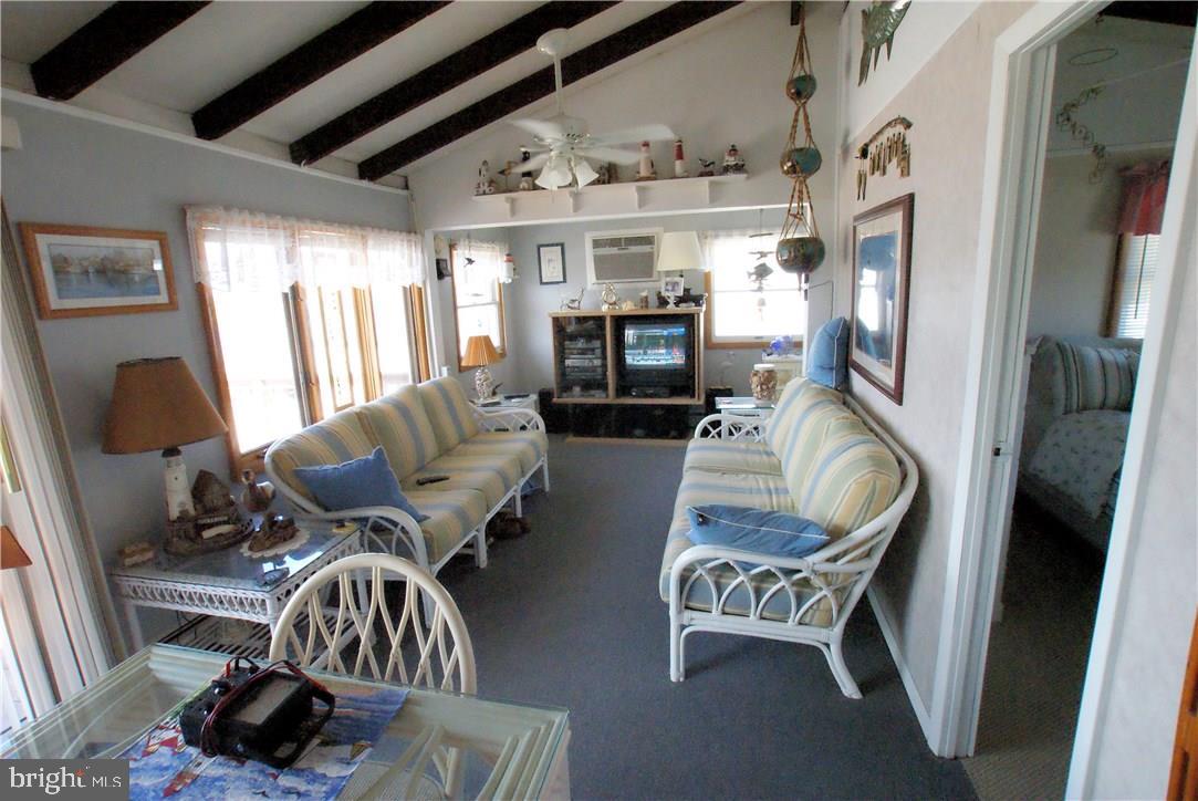 405 Kingfisher Road Tuckerton, NJ 08087 - Photo 11 of 16 a living room with furniture and a chandelier