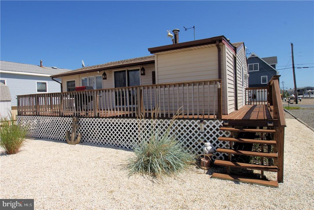 405 Kingfisher Road Tuckerton, NJ 08087 - Photo 3 of 16 a view of a house with a large window and wooden fence