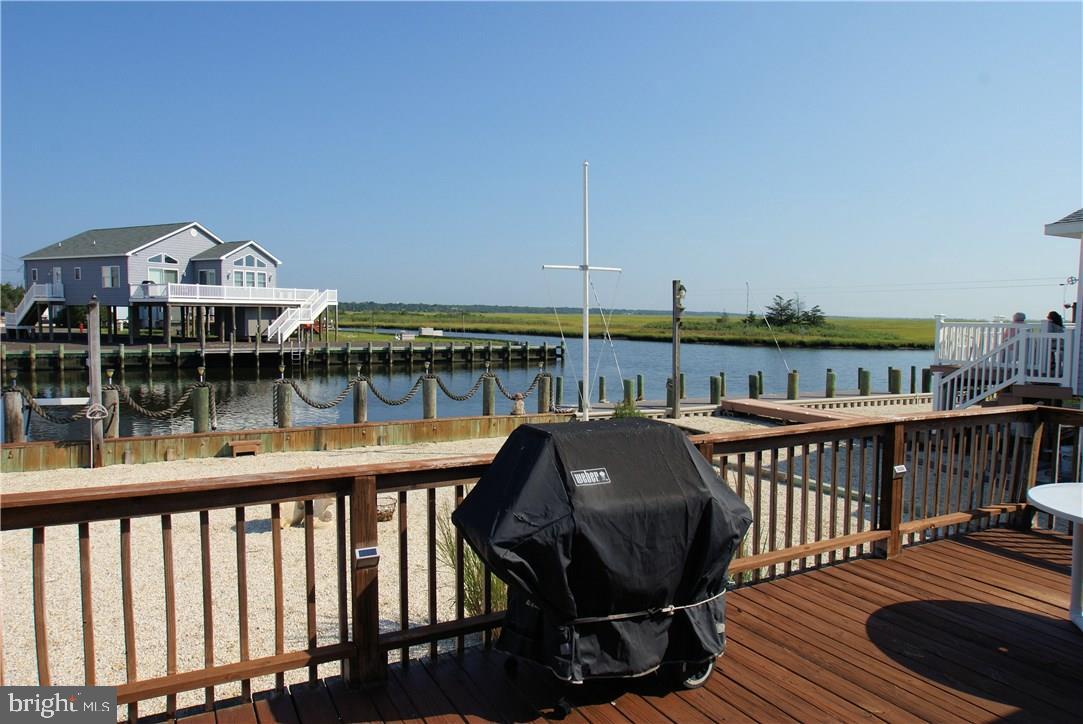 405 Kingfisher Road Tuckerton, NJ 08087 - Photo 6 of 16 a view of a roof deck with table and chairs a barbeque