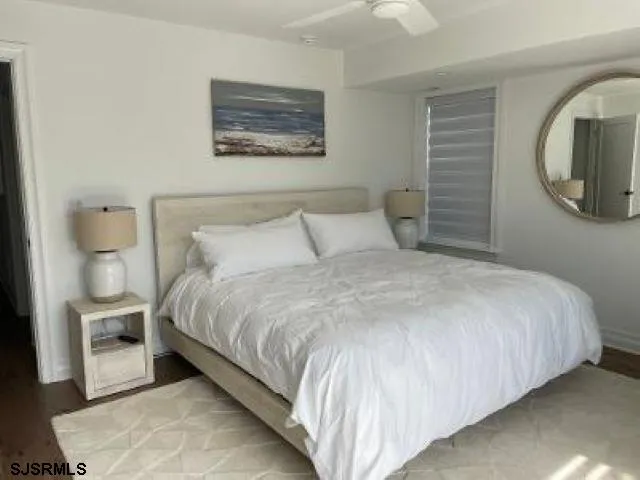 a large bed sitting in a bedroom next to a window