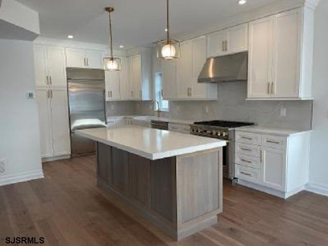 103 North Monroe Avenue, Unit MAY 15TH 2026JULY 31ST 2026 Margate City, NJ 08402 - Photo 2 of 33 a kitchen that has a lot of cabinets and wooden floor