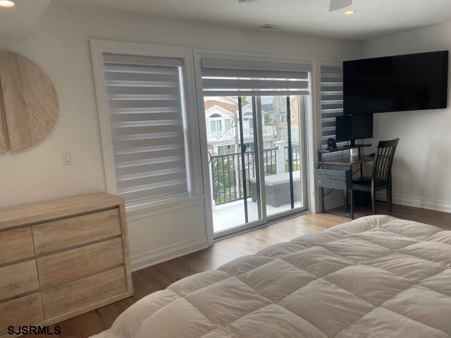 103 North Monroe Avenue, Unit MAY 15TH 2026JULY 31ST 2026 Margate City, NJ 08402 - Photo 21 of 33 a view of a bedroom with cabinet and a flat screen tv