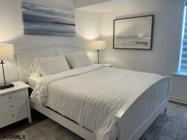 a bedroom with a bed and a night stand