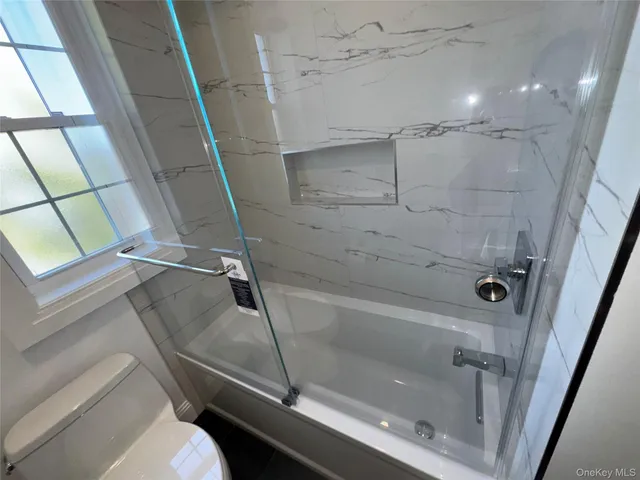 a bathroom with a sink a mirror and a shower