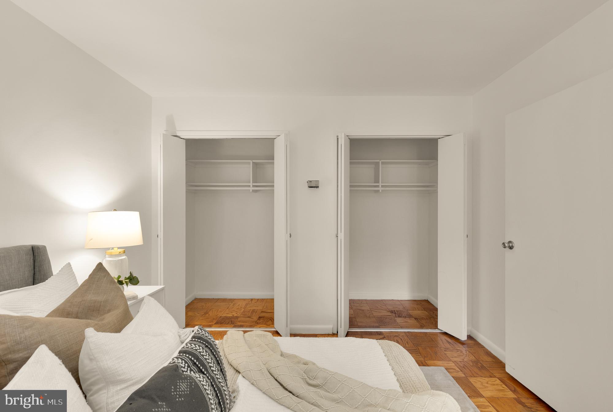 2400 41st Street Northwest, Unit 212 Washington, DC 20007 - Photo 17 of 24 a bedroom with a bed and a lamp