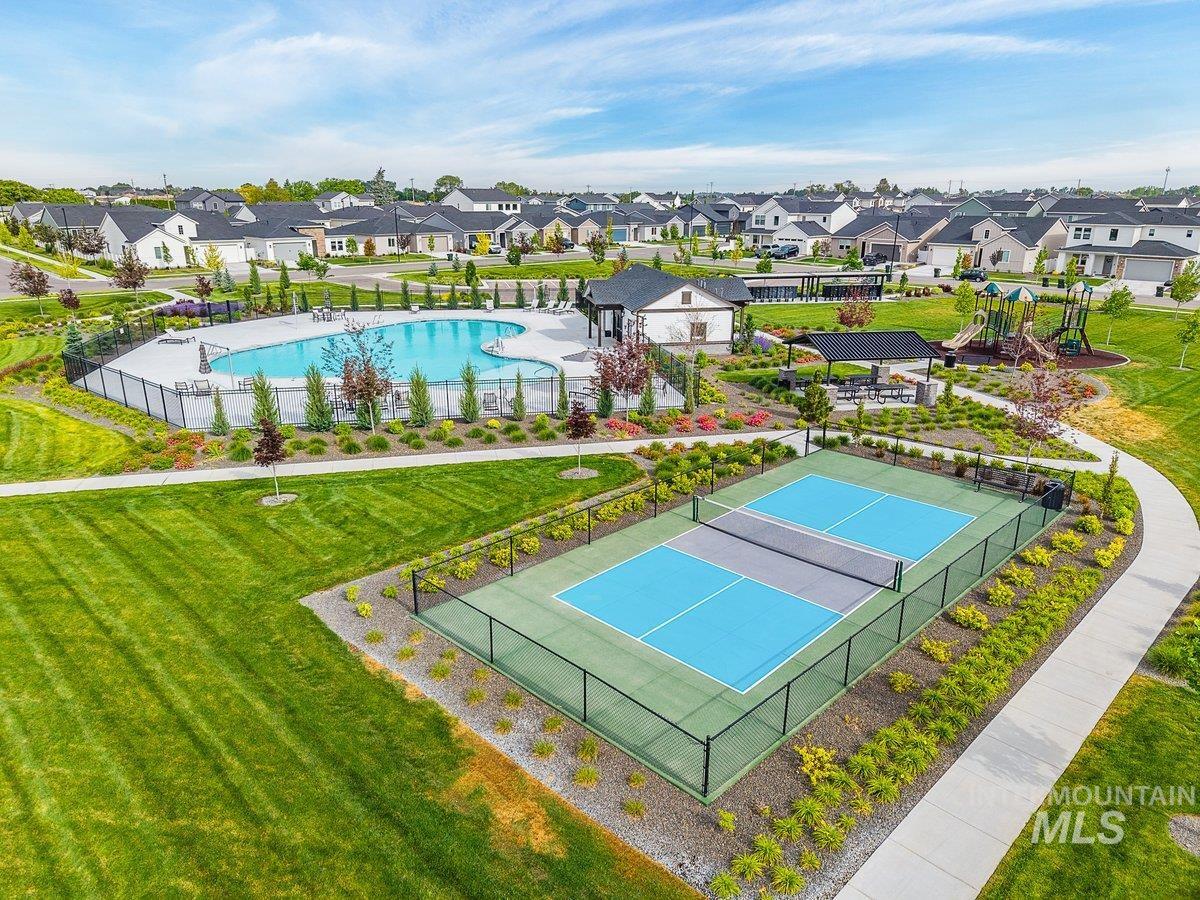 1380 West Chilitna Street Meridian, ID 83642 - Photo 49 of 50 Community amenities including a swimming pool with lounge seating, two pickleball courts, covered picnic areas, and a playground