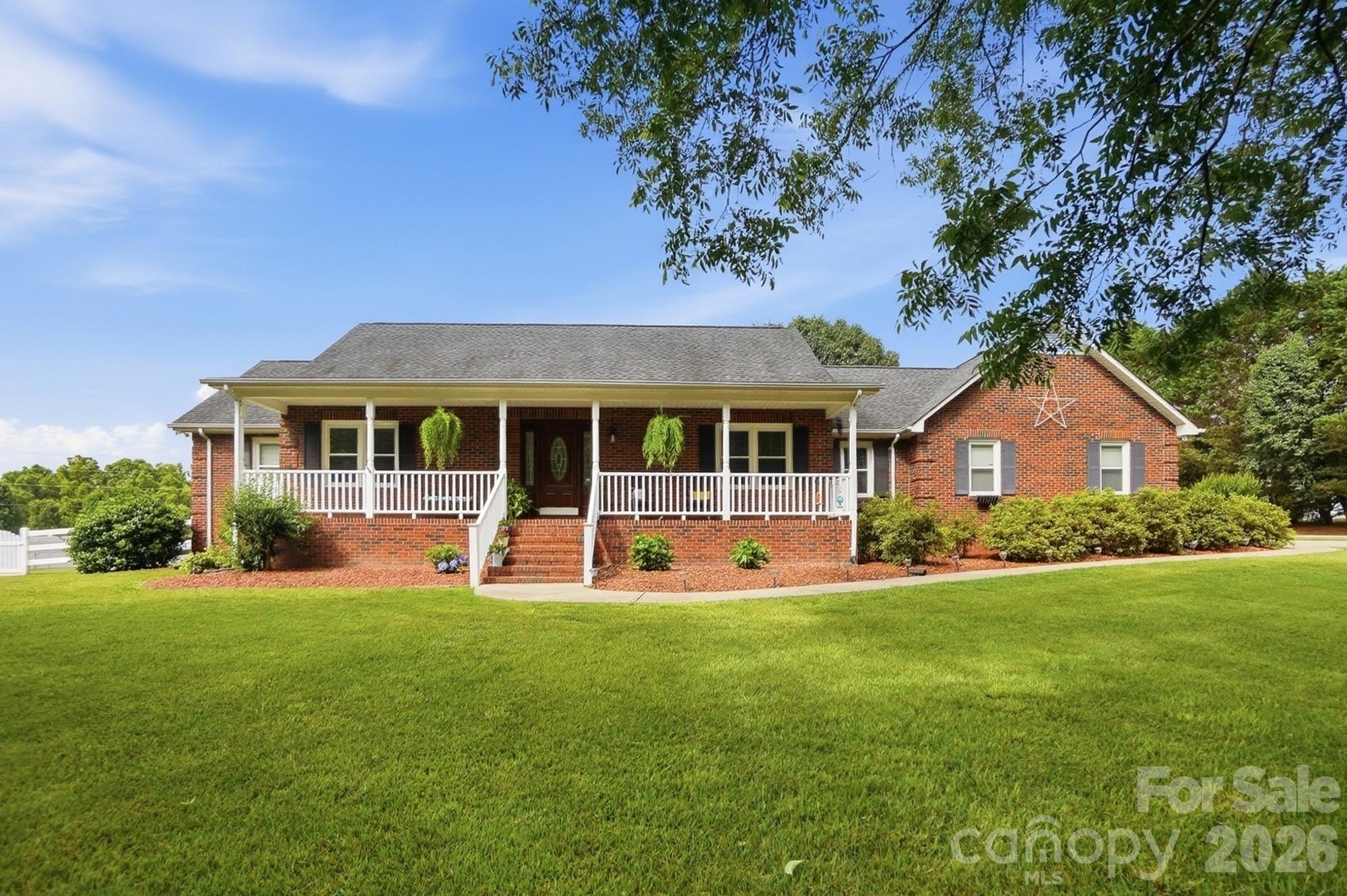4017 Mullis Newsome Road Monroe, NC 28110 - Photo 9 of 38 a front view of a house with a yard and porch