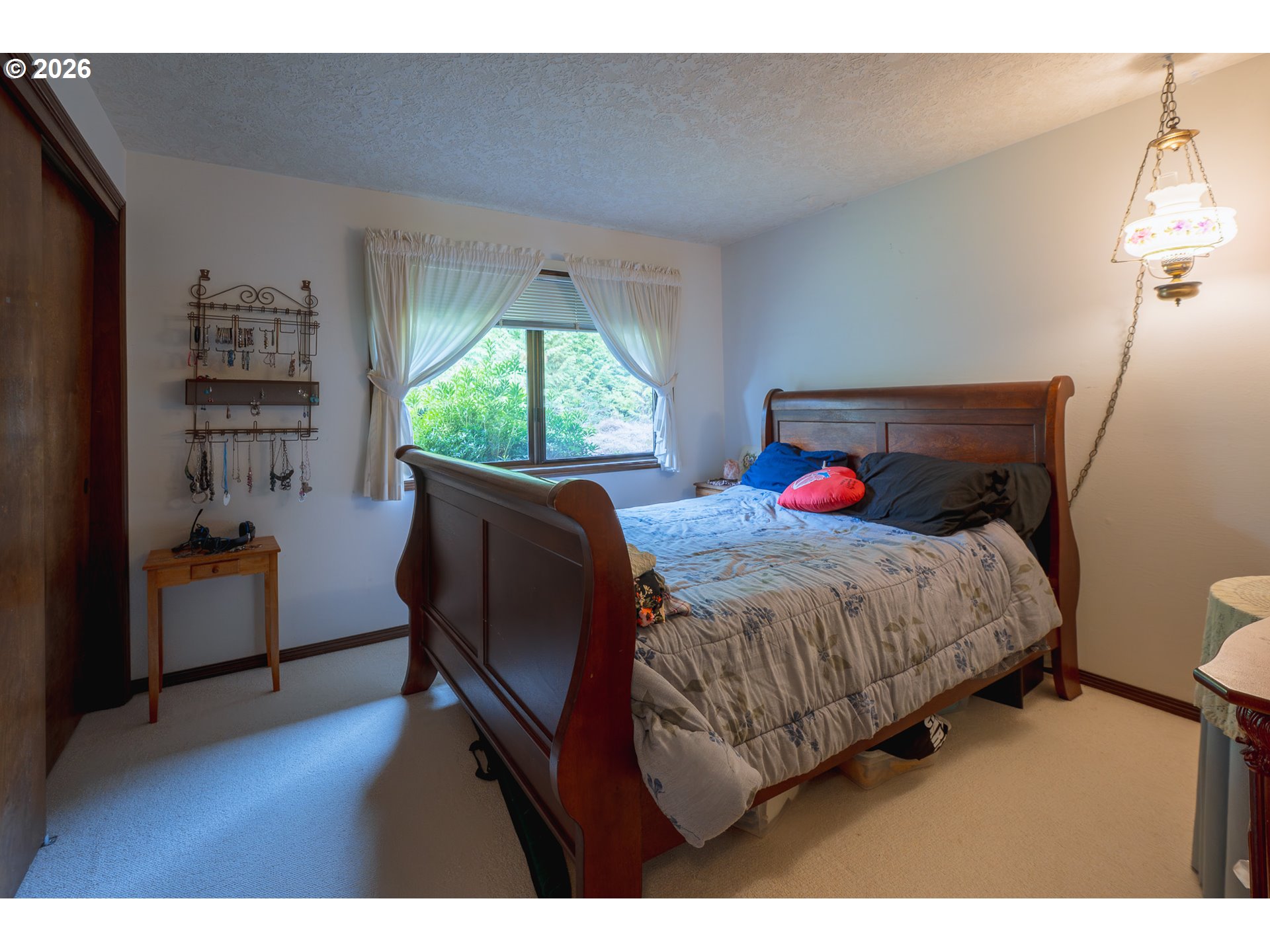 76382 Delena Mayger Road Rainier, OR 97048 - Photo 26 of 36 a bed sitting in a bedroom next to a window