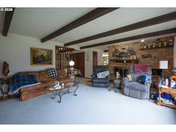 a living room with furniture and a floor to ceiling window