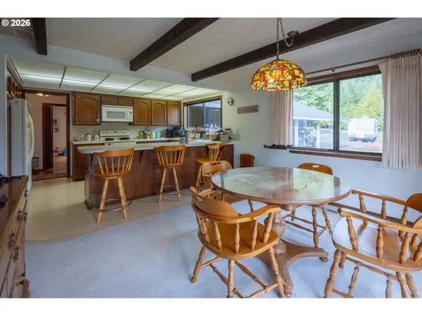 a kitchen with wooden cabinets sink and window
