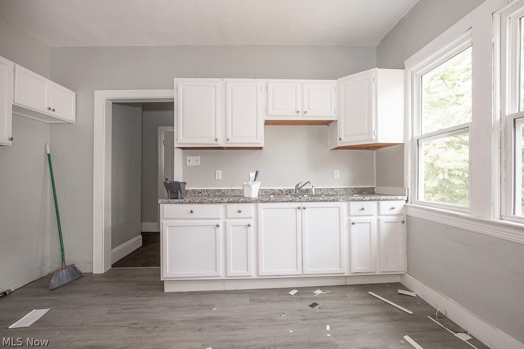 1000 Eddy Road Cleveland, OH 44108 - Photo 27 of 38 Kitchen with white cabinets, light wood-style floors, and light stone countertops