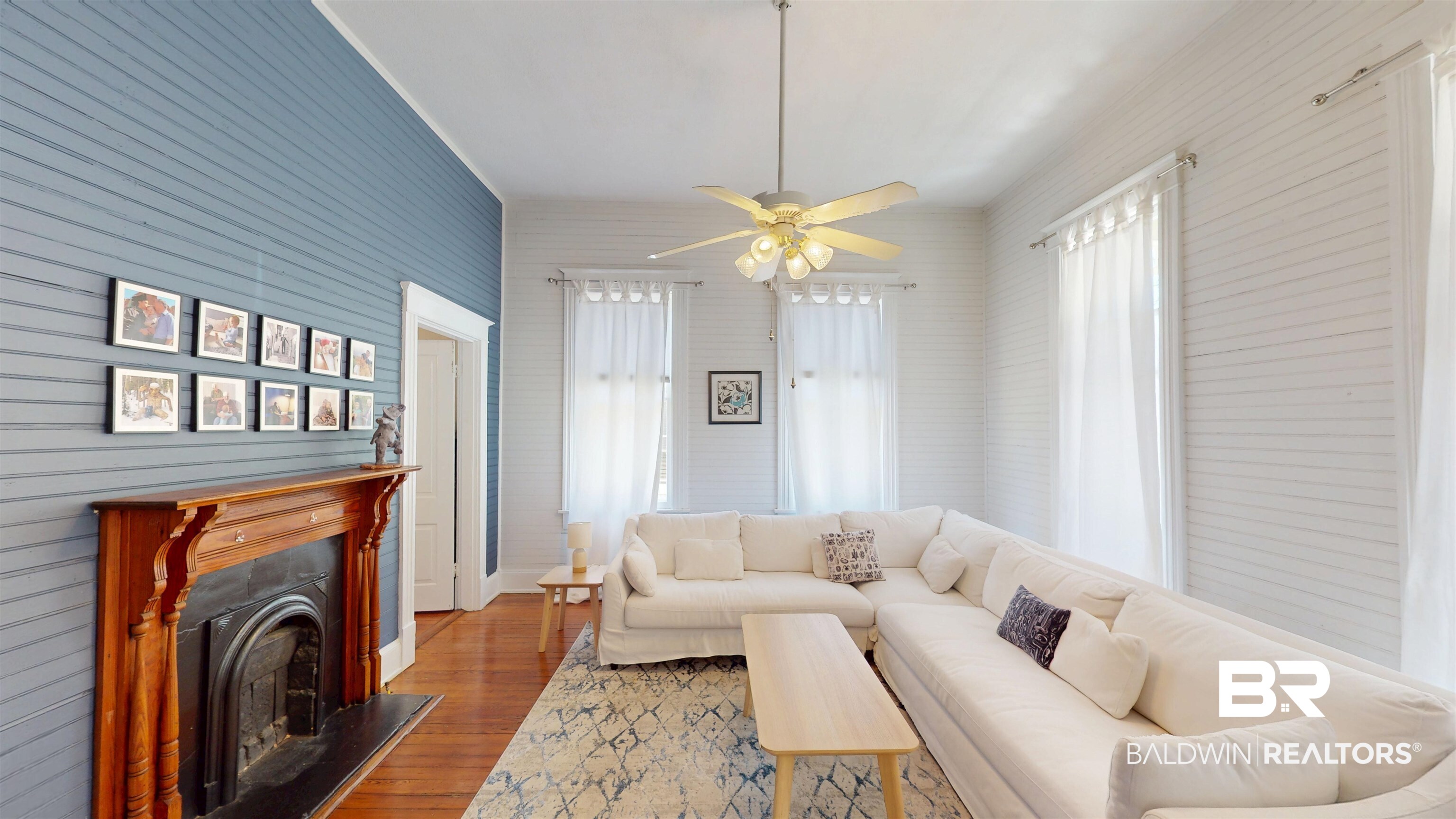 1154 New St Francis Street Mobile, AL 36604 - Photo 12 of 37 Living area featuring a fireplace, a ceiling fan, and wood finished floors