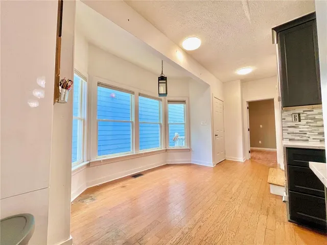 a view of an empty room with fire place