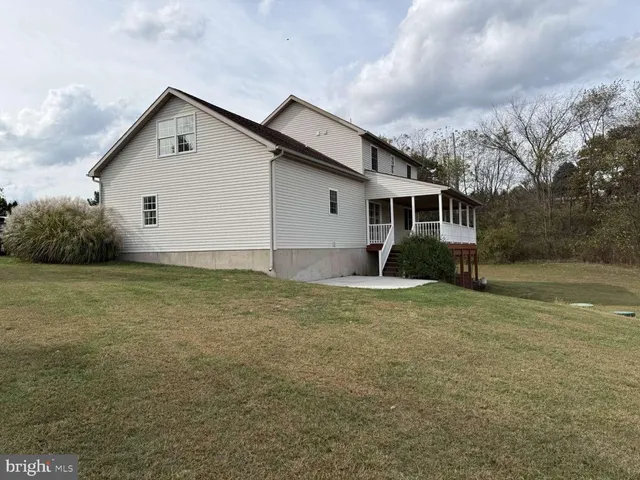 a front view of house with yard and trees