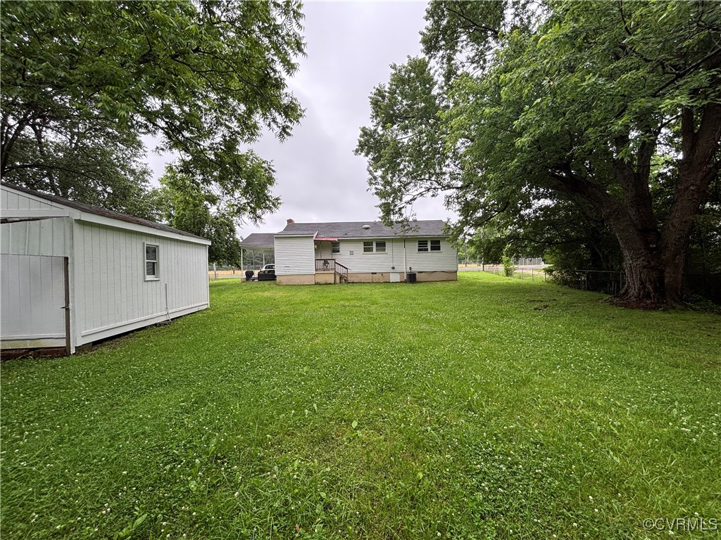 4704 River Road Petersburg, VA 23803 - Photo 12 of 17 View of grassy yard featuring an outdoor structure