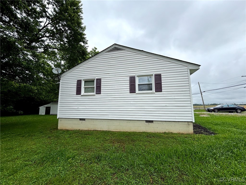View of side of property featuring crawl space and