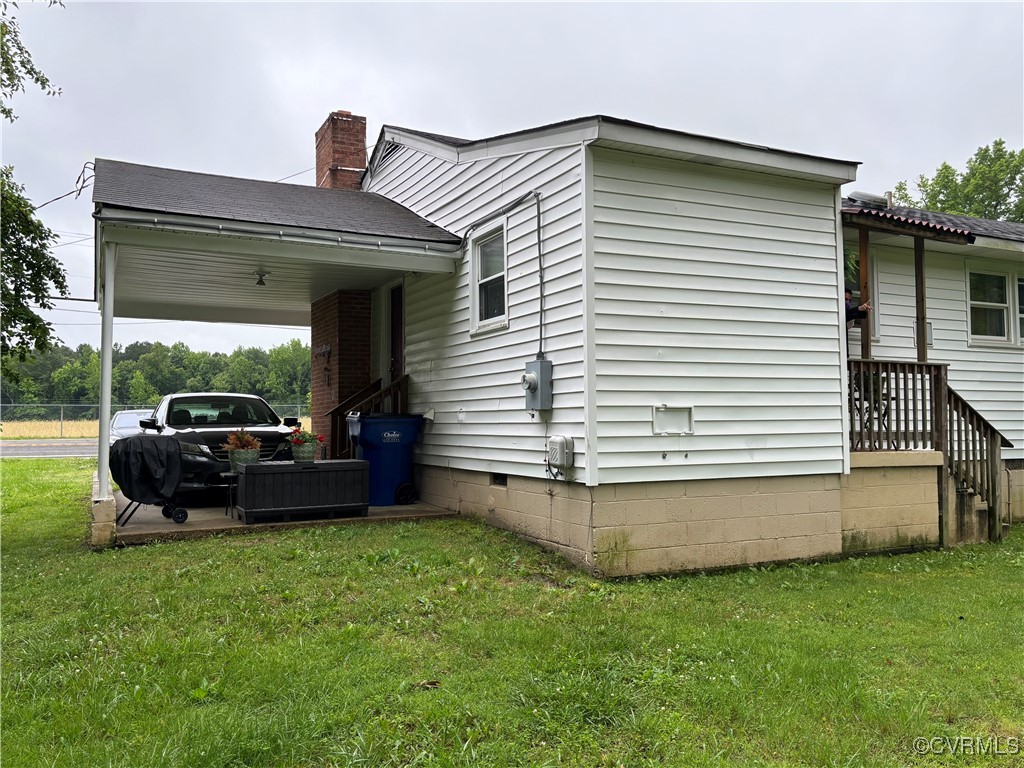 4704 River Road Petersburg, VA 23803 - Photo 8 of 17 View of home's exterior with a yard, a carport, an