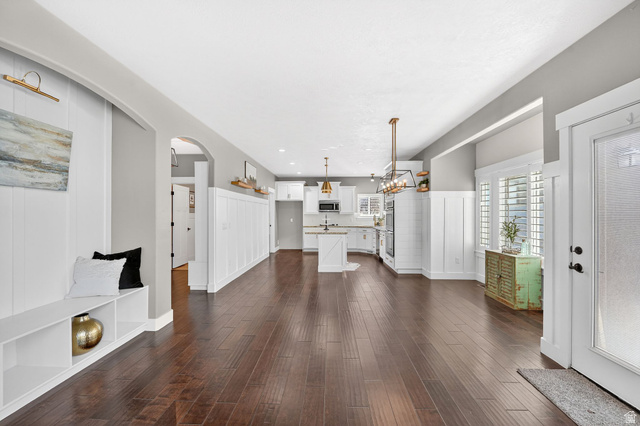 14714 South Bright Wood Road Herriman, UT 84096 - Photo 11 of 41 View of Dining /Kitchen with a wainscoted wall, dark wood-style floors, a decorative wall, a chandelier, and recessed lighting