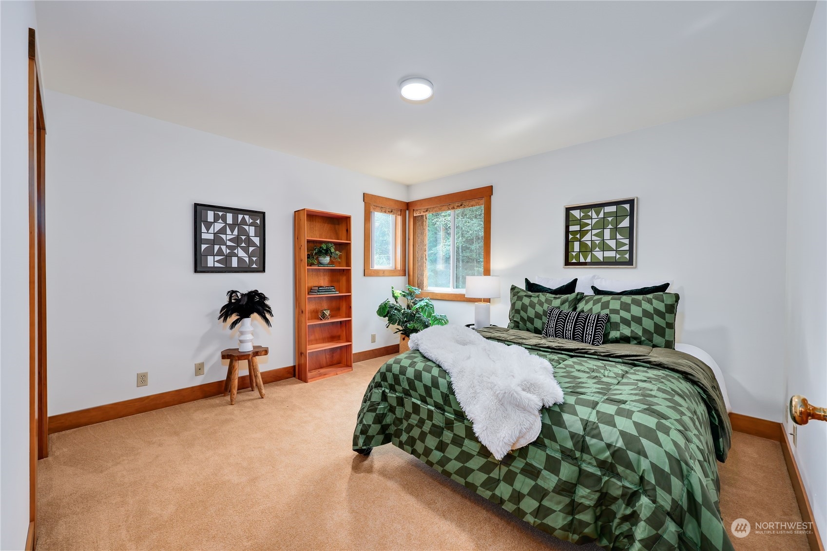 5701 Northeast Gunderson Road Poulsbo, WA 98370 - Photo 14 of 40 a bed sitting in a bedroom next to a window