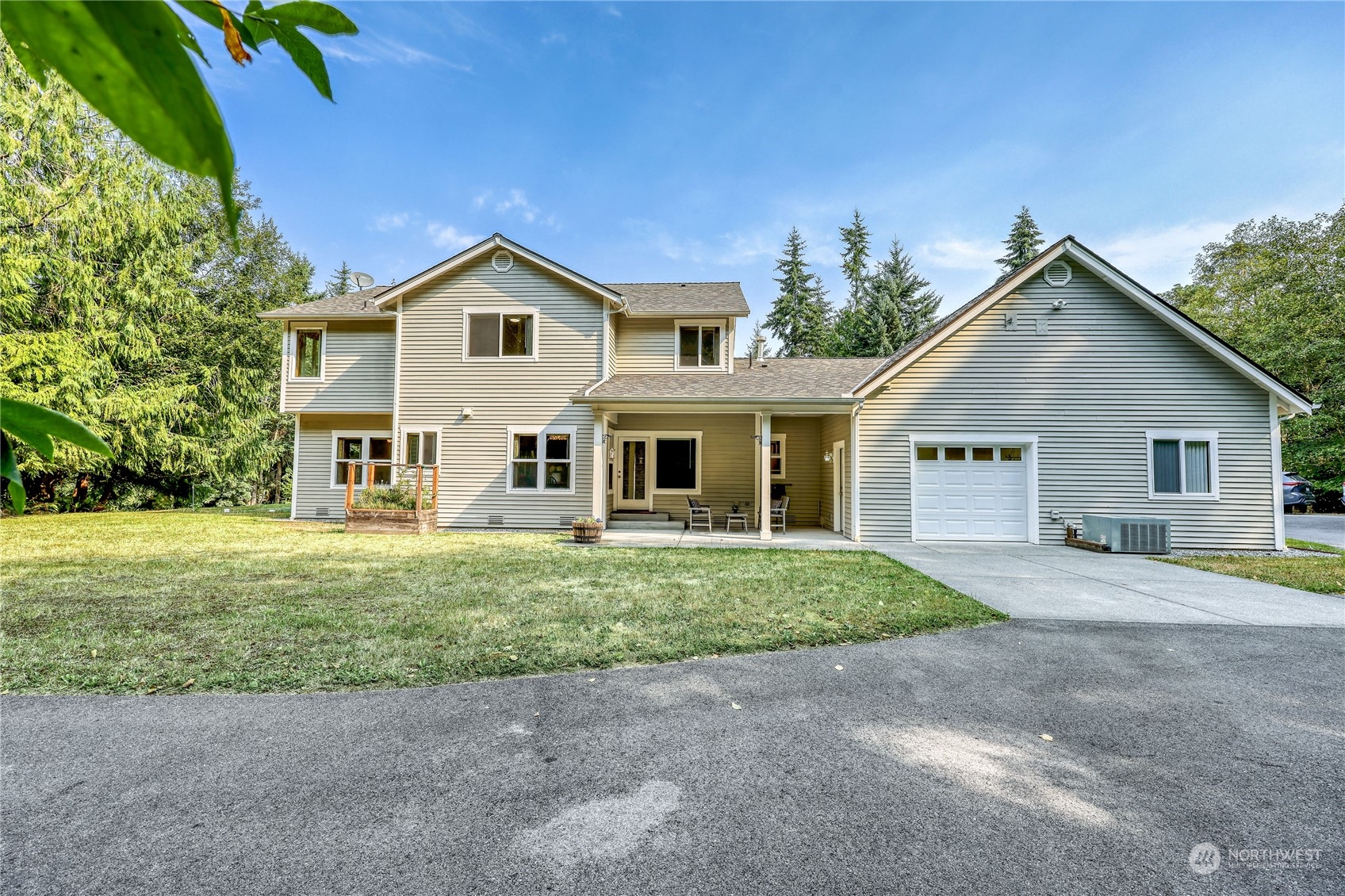5701 Northeast Gunderson Road Poulsbo, WA 98370 - Photo 21 of 40 a front view of a house with a yard and garage