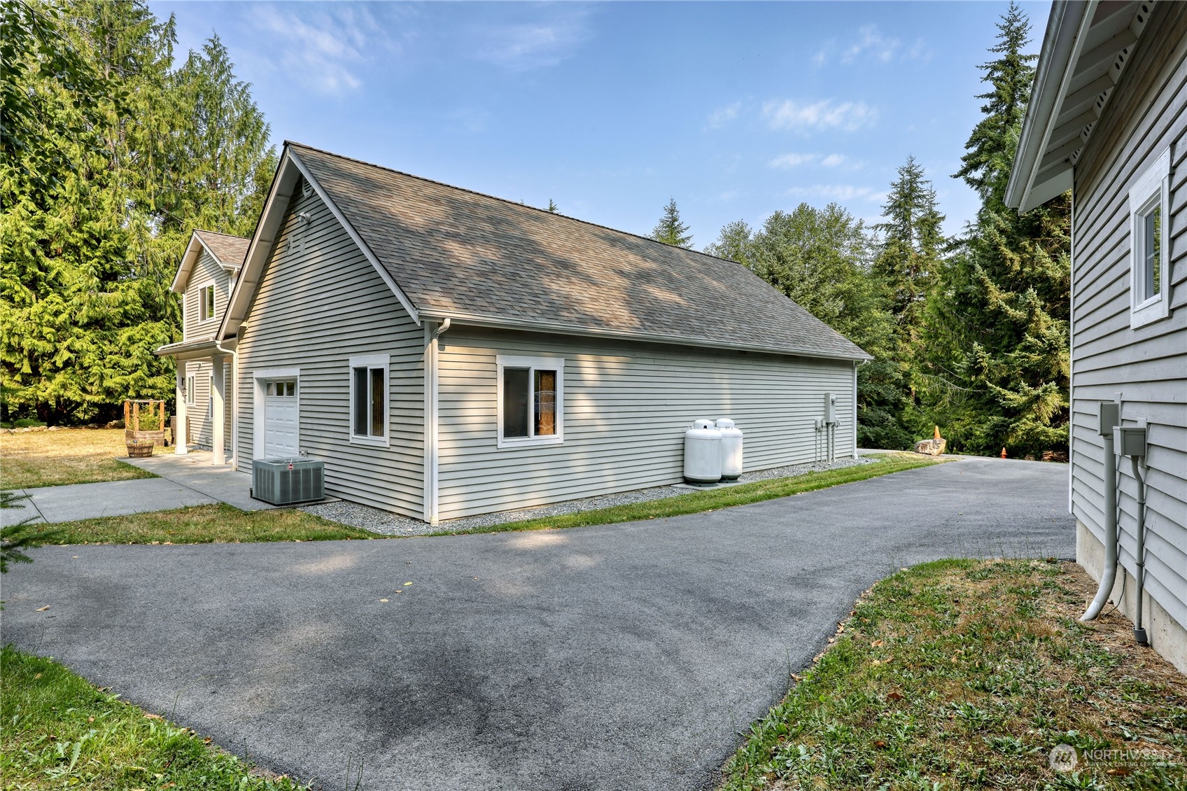 5701 Northeast Gunderson Road Poulsbo, WA 98370 - Photo 27 of 40 a view of a house with backyard and trees