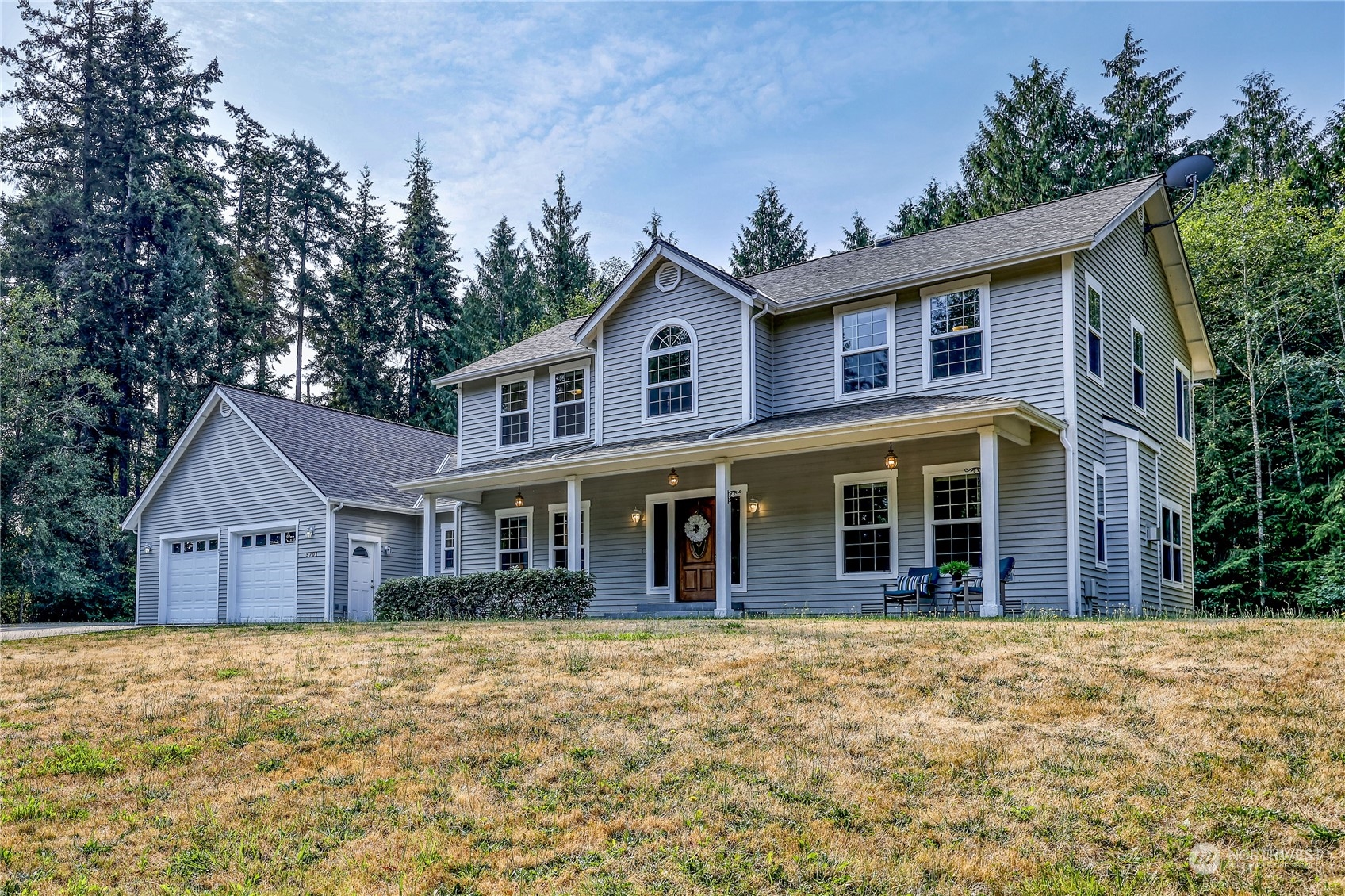 5701 Northeast Gunderson Road Poulsbo, WA 98370 - Photo 34 of 40 a front view of a house with a yard