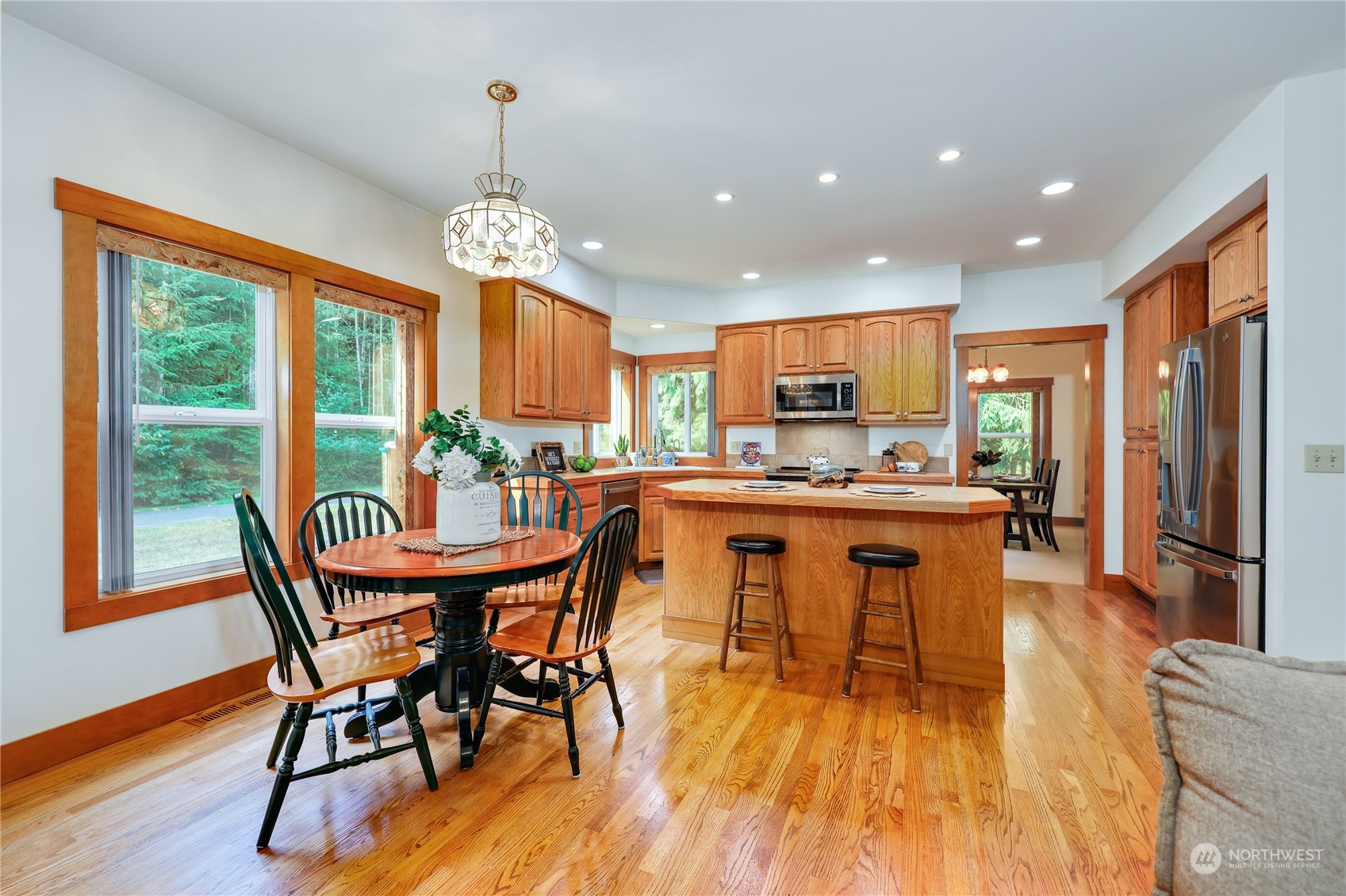 5701 Northeast Gunderson Road Poulsbo, WA 98370 - Photo 6 of 40 a view of a dining room with furniture window and wooden floor