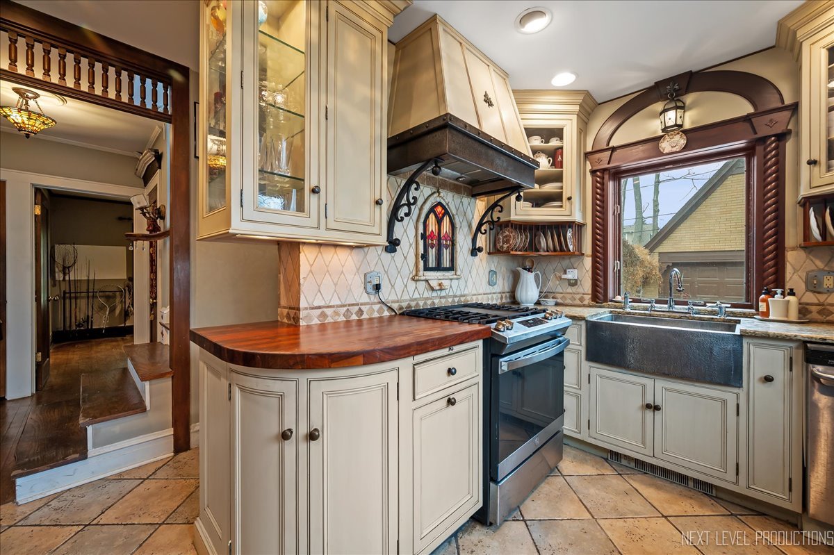640 Anderson Boulevard Geneva, IL 60134 - Photo 17 of 41 a kitchen with stainless steel appliances granite countertop a sink and a stove