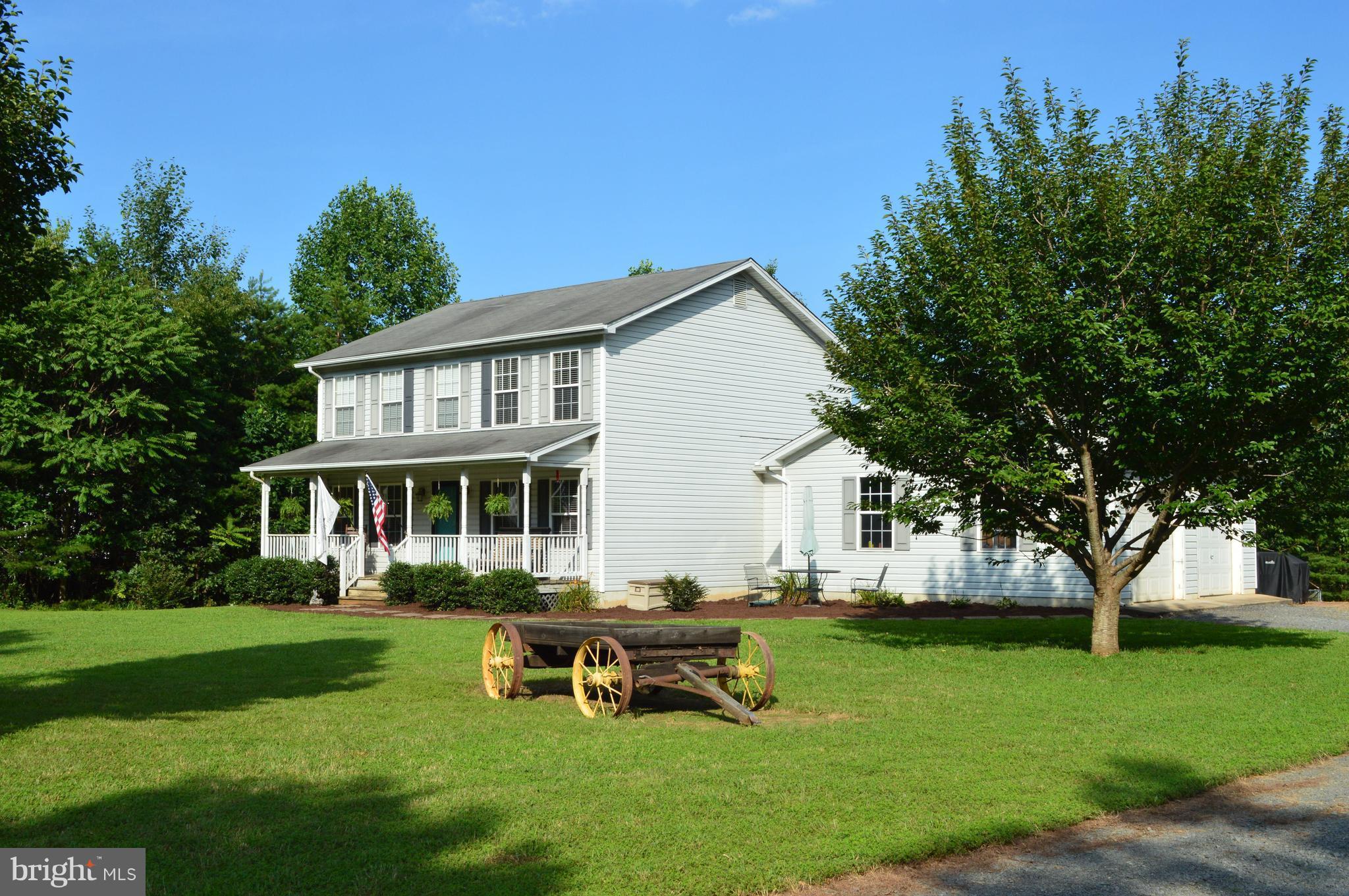 a view of a house with a yard porch and sitting area