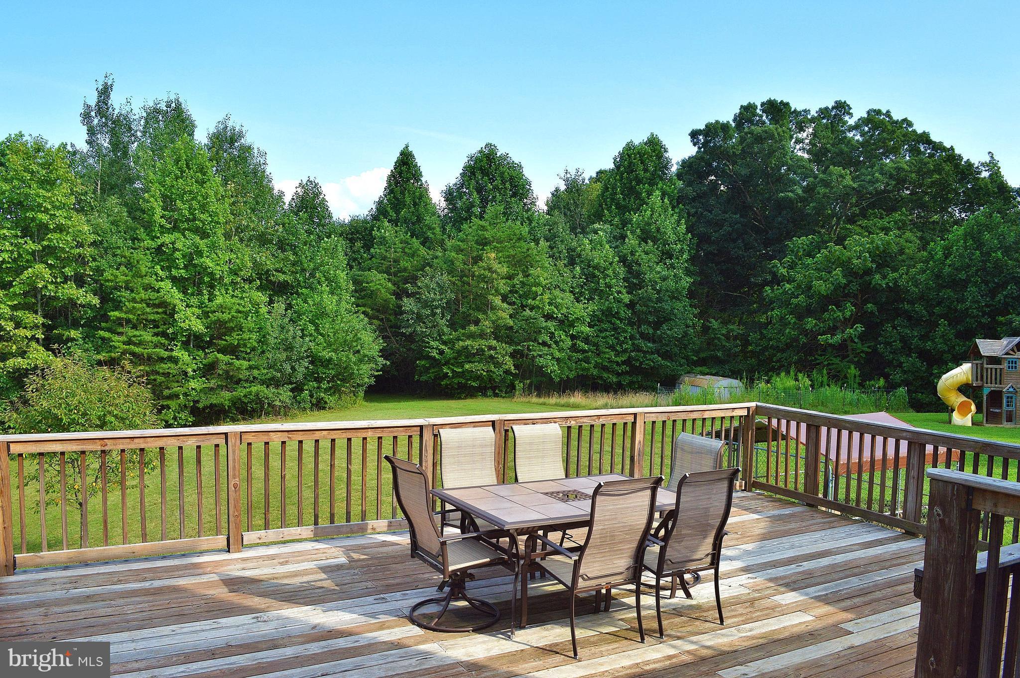 9015 Old Stillhouse Road Rixeyville, VA 22737 - Photo 15 of 21 a view of a wooden deck with furniture