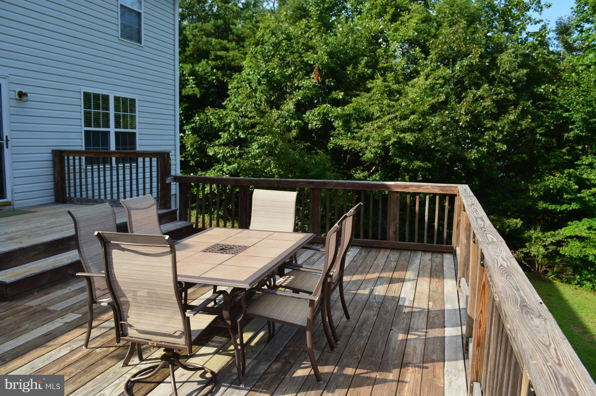 9015 Old Stillhouse Road Rixeyville, VA 22737 - Photo 16 of 21 a view of balcony with wooden floor and outdoor seating